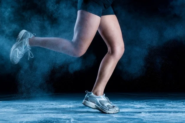 Athlete running in blue background