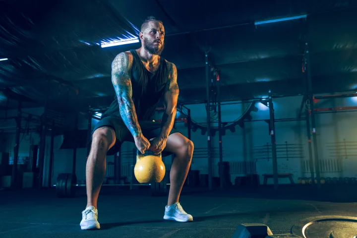 Man training with kettle ball